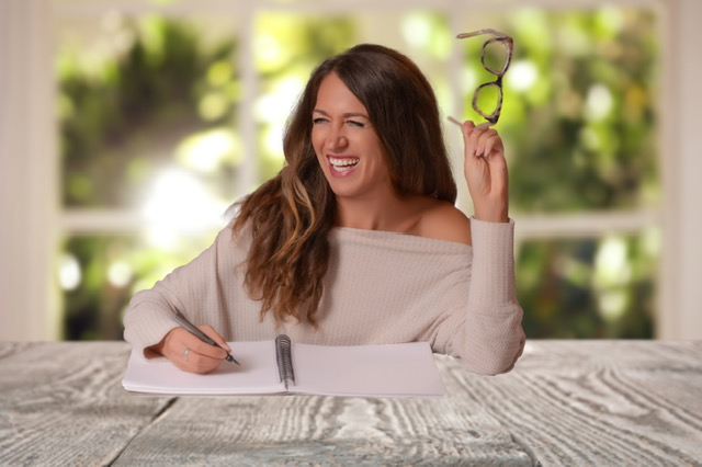 Julie Ann Lucca writing at a table